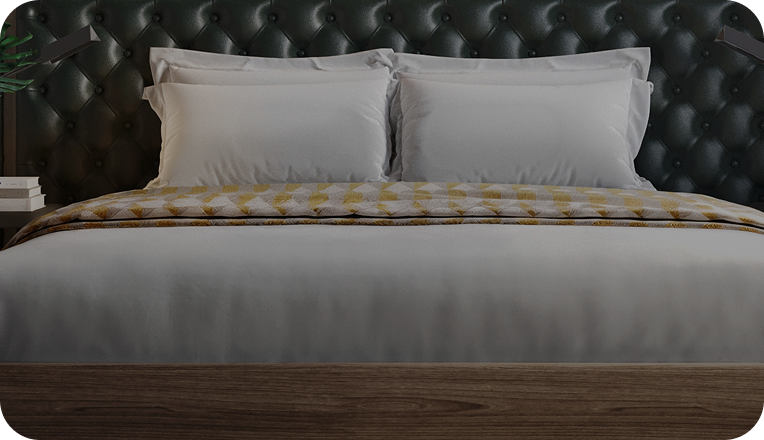 Image of a bed with white linens and pillows