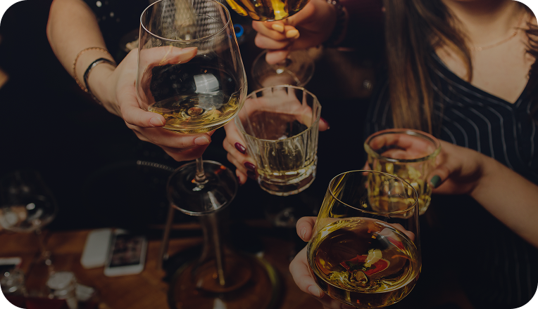 Image of a social gathering of friends toasting with drinks